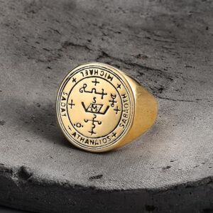 Stainless steel Archangel Michael seal ring on textured stone background