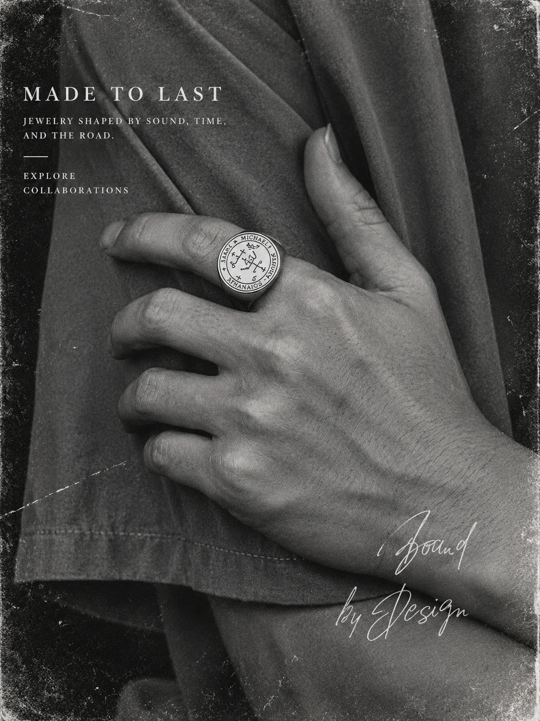 Archangel Michael seal ring worn on a hand in a black-and-white portrait.