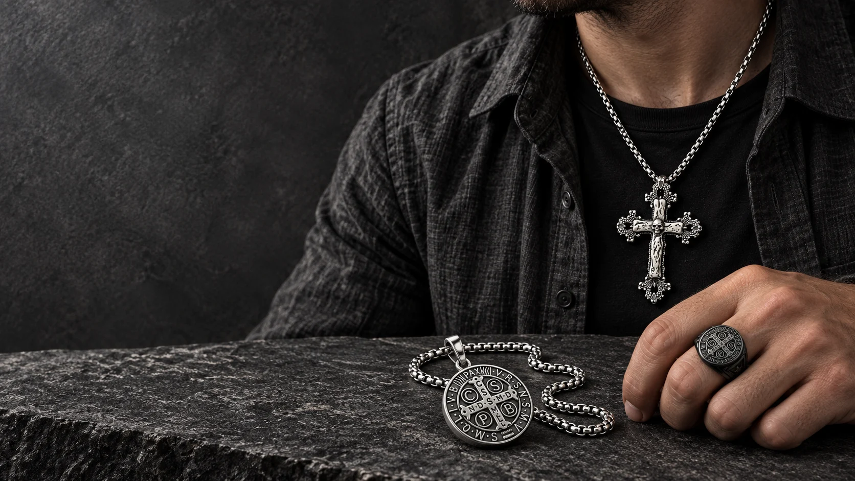 Religious jewelry styling with an ornate cross necklace, Saint Benedict medallion and ring